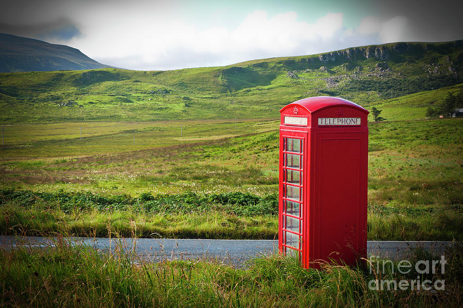 Typical red English telephone box in a rural area near a road. Photograph by Joaquin Corbalan