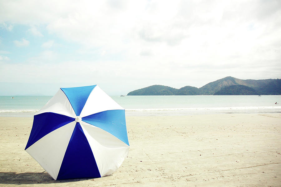 Umbrella On Sand Photograph by Grace Oda