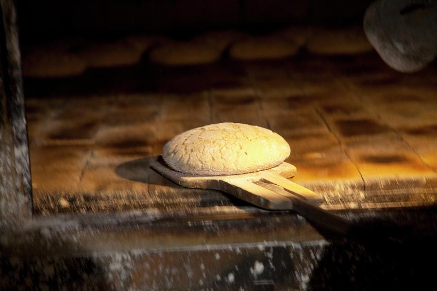 Unbaked Bread On A Wooden Bread Peel In The Oven Photograph by Studio Lipov