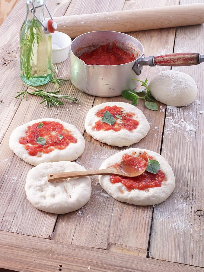 Summer Photograph - Unbaked Pizzas With Tomato Sauce by Nikolai Buroh