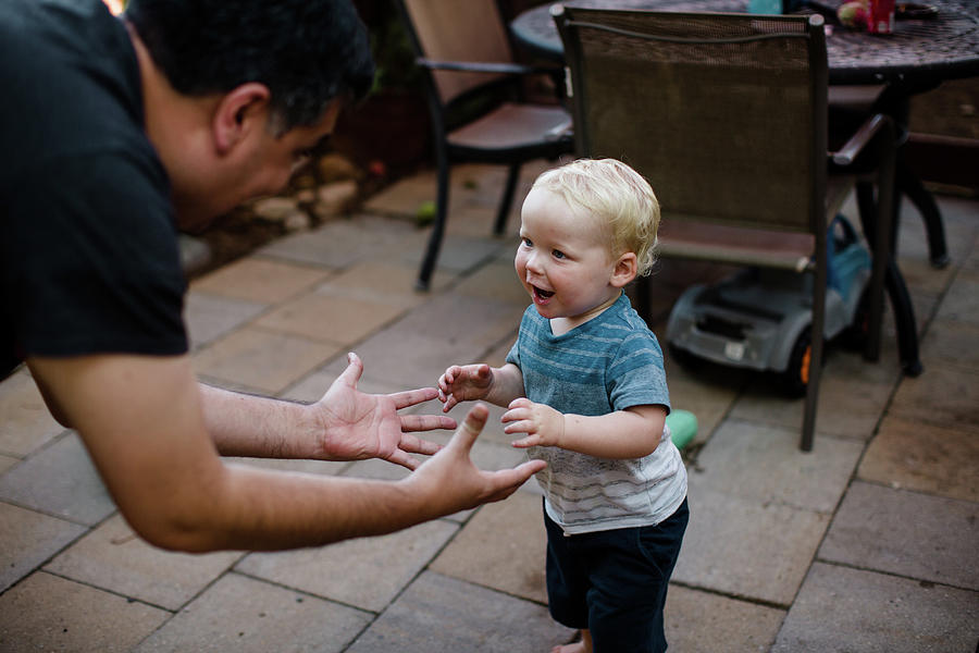 San Diego Photograph - Uncle Playing With Nephew In Yard In San Diego by Cavan Images