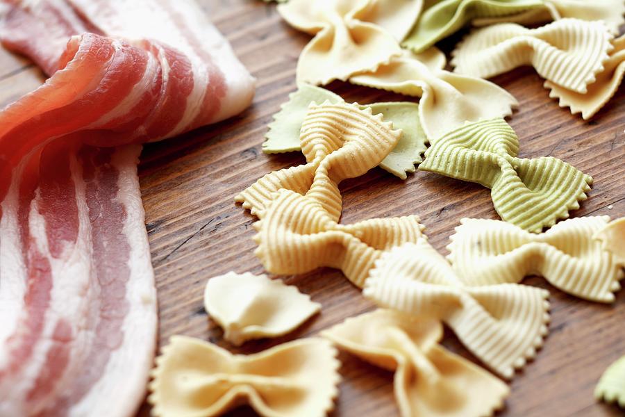 Uncooked Bacon And Tri-color Bowtie Pasta Photograph by Edward Thomas