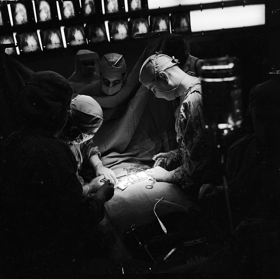 Under The Knife Photograph by George Pickow