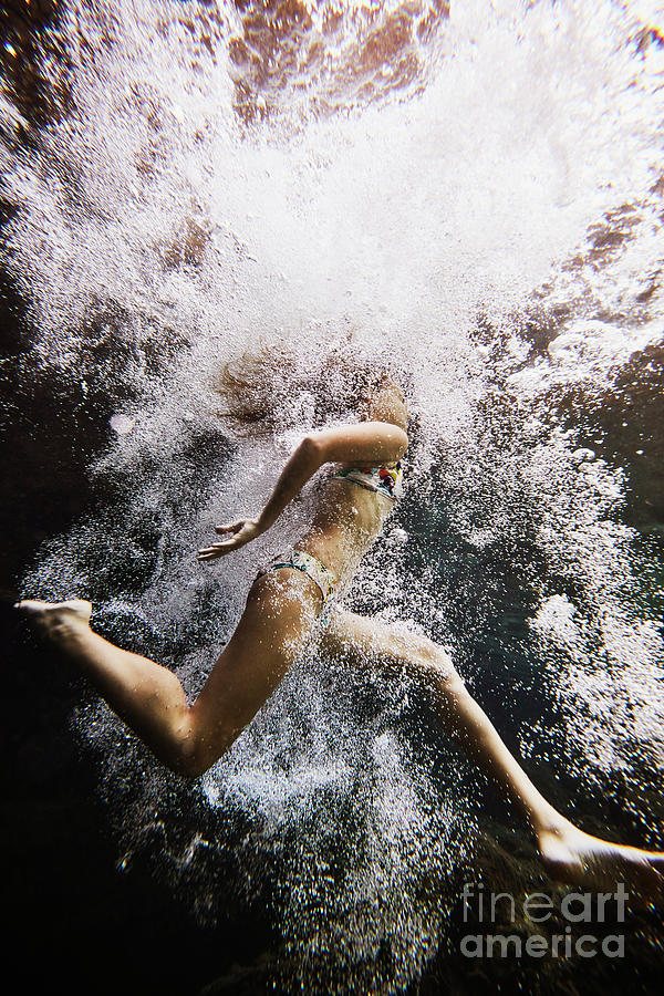 Underwater View Of Girl Jumping Photograph by Thomas Barwick