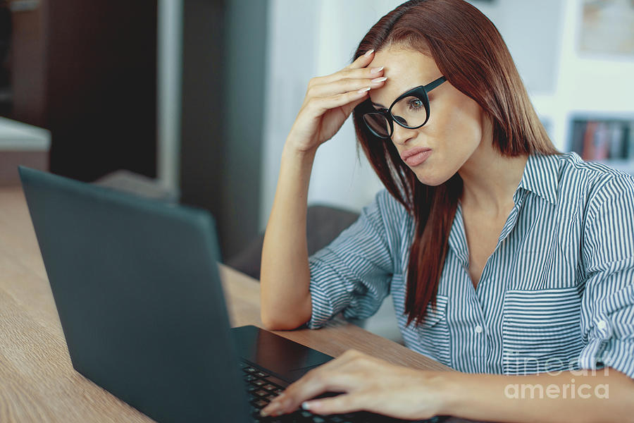 Unhappy Woman Using Laptop Photograph by Sakkmesterke/science Photo Library
