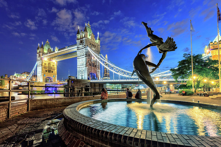 United Kingdom, England, London, Great Britain, City Of London, Tower Bridge And The Girl With A Dolphin Fountain By Night Digital Art by Maurizio Rellini