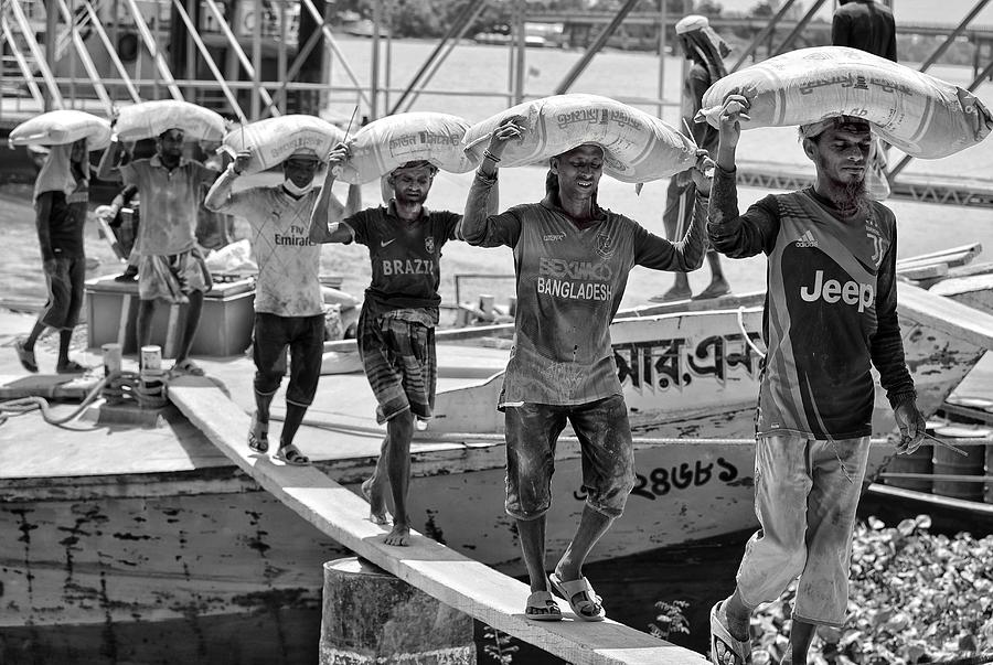 Black And White Photograph - Unloading Cement Sacks by Mostafijur Rahman Nasim