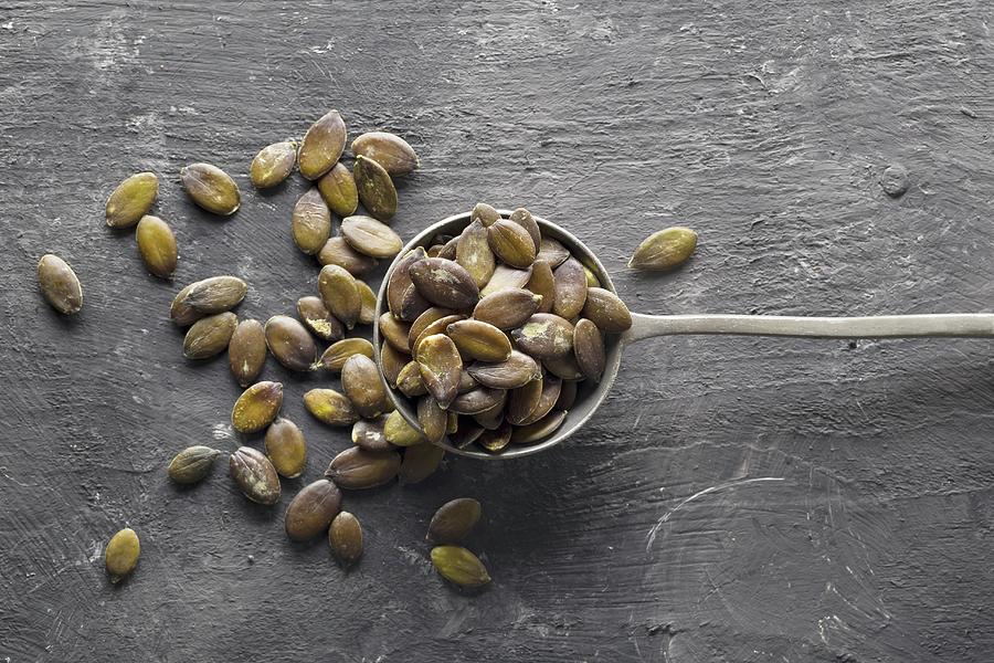 Unpeeled Pumpkin Seeds In An Old Spoon Photograph by Shawn Hempel