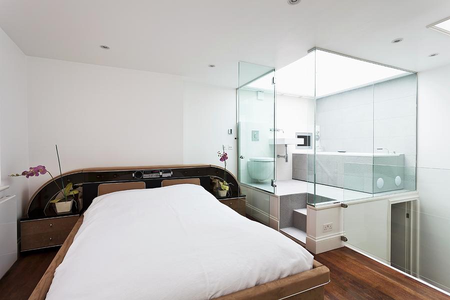 Unusual Bedroom On Mezzanine With Bathroom In Adjacent Glass Cubicle Photograph by Simon Maxwell Photography