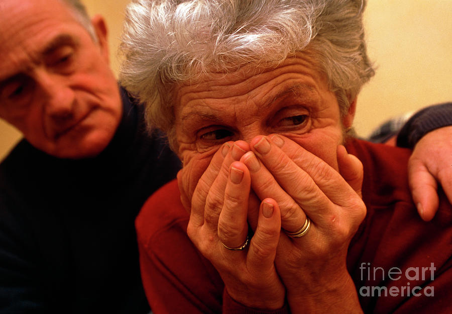 Upset Elderly Woman Comforted By Elderly Man Photograph by Conor Caffrey/science Photo Library