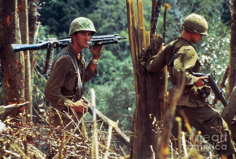 Us Soldiers Walking With Guns Atop Hill Photograph by Bettmann