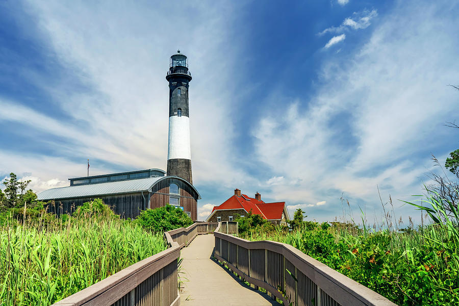 Usa, New York, Long Island, Wooden Path Leading To Fire Island Lighthouse Surrounded By Sand Grass And Green Trees. Digital Art by Alejandra Uribe Posada