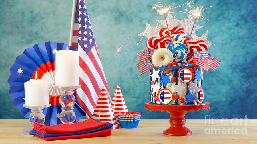 USA theme candyland fantasy drip cake in party table setting. Photograph by Milleflore Images