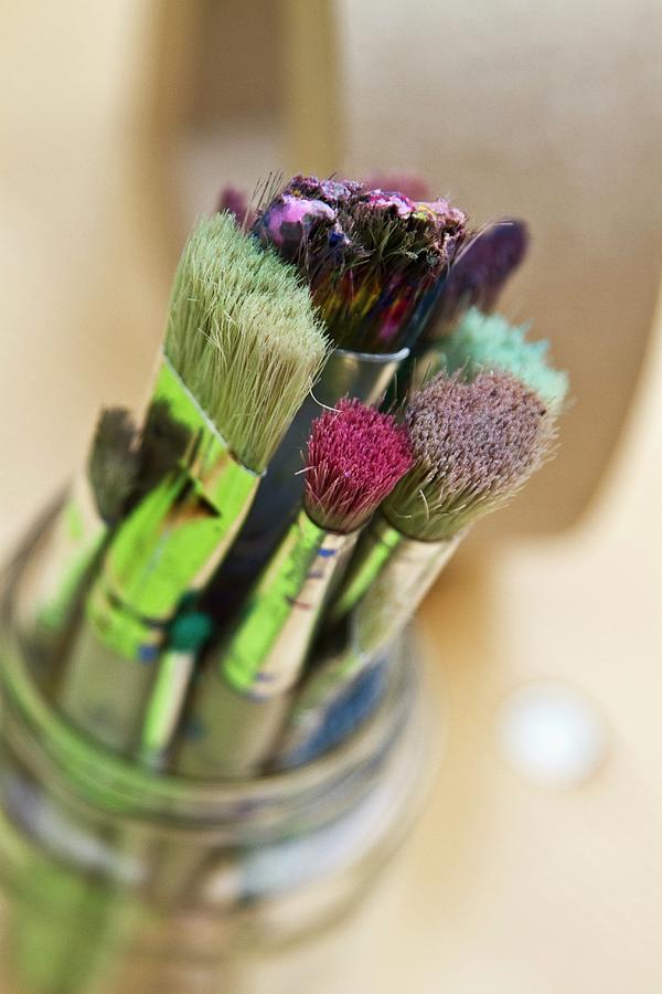 Used Paintbrushes In Glass Jar Photograph by Catja Vedder