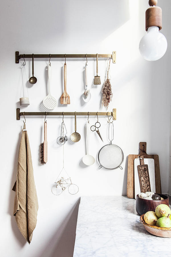 Utensils Hung From Hook Rails In Kitchen With Wooden Cabinets Photograph by Holly Marder