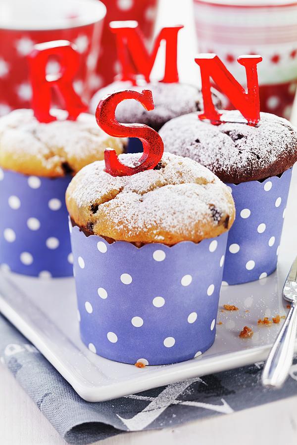 Vanilla And Chocolate Muffins In Polka Dot Paper Cases With Red Sugar Letters Photograph by Franziska Taube