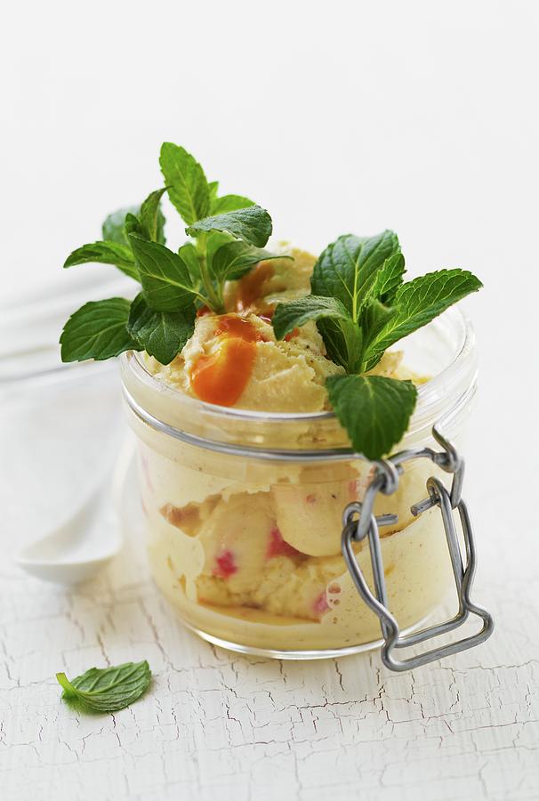 Vanilla And Strawberry Ice Cream With Fruit Sauce And Mint In A Mason Jar Photograph by Valeria Aksakova