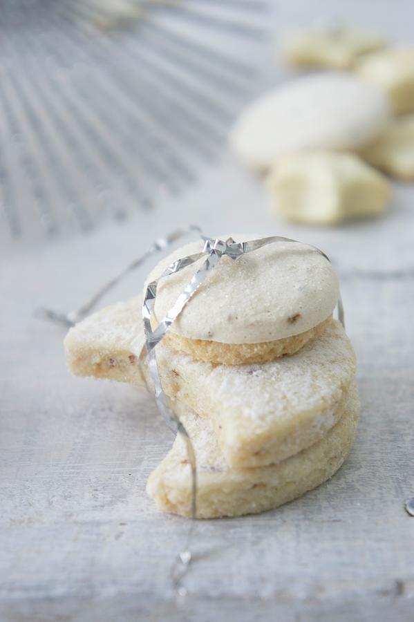 Vanilla Biscuits And Star Anise Biscuits Tied With Tinsel Photograph by Martina Schindler