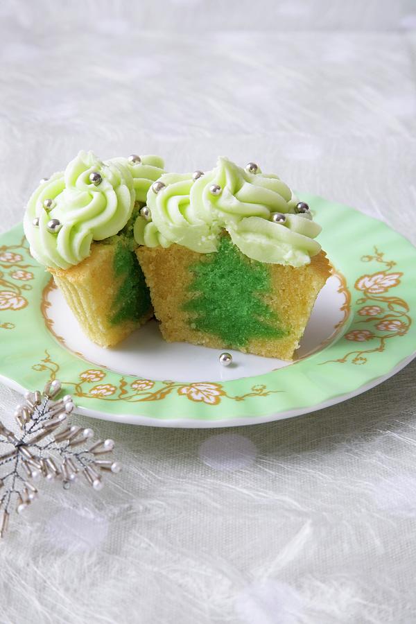 Vanilla Cupcake With A Green Tree Center And Green Frosting With Decorative Silver Balls; Halved Photograph by Joy Skipper Foodstyling