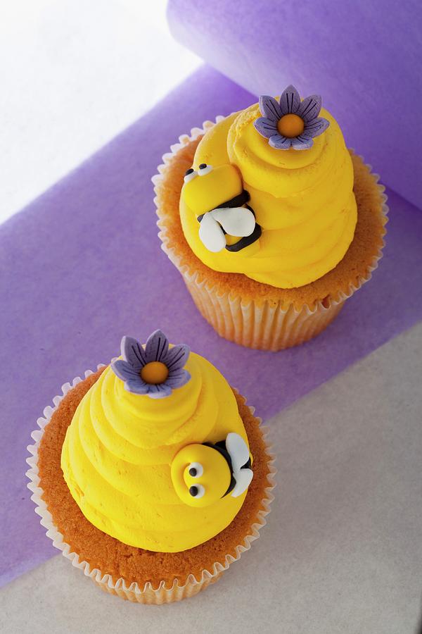 Vanilla Cupcakes With Lemon Buttercream And Bees Made From Fondant Icing Photograph by Creative Photo Services