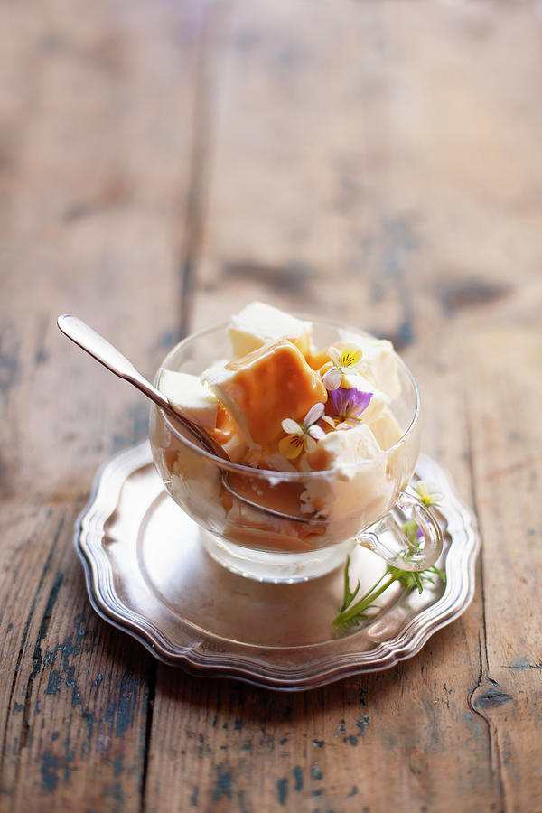 Vanilla Ice Cream With Caramel Sauce And Viola Flowers Photograph by Alicja Koll