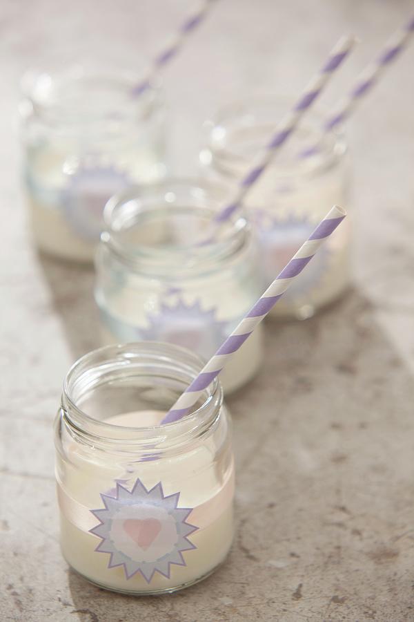Vanilla Milkshakes In Jam Jars Decorated With Stickers And Striped Drinking Straws Photograph by Great Stock!