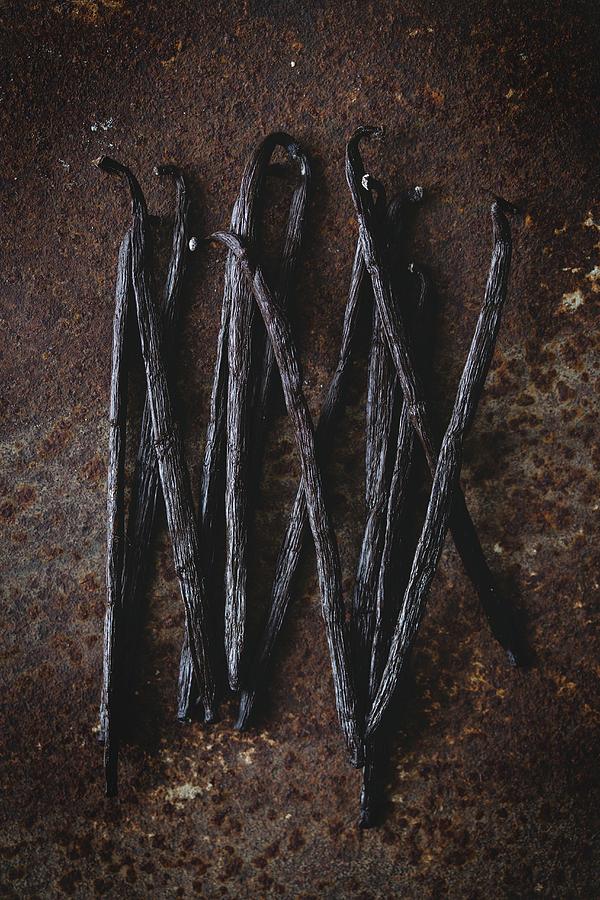 Vanilla Pods On A Rusty Surface Photograph by Malgorzata Laniak