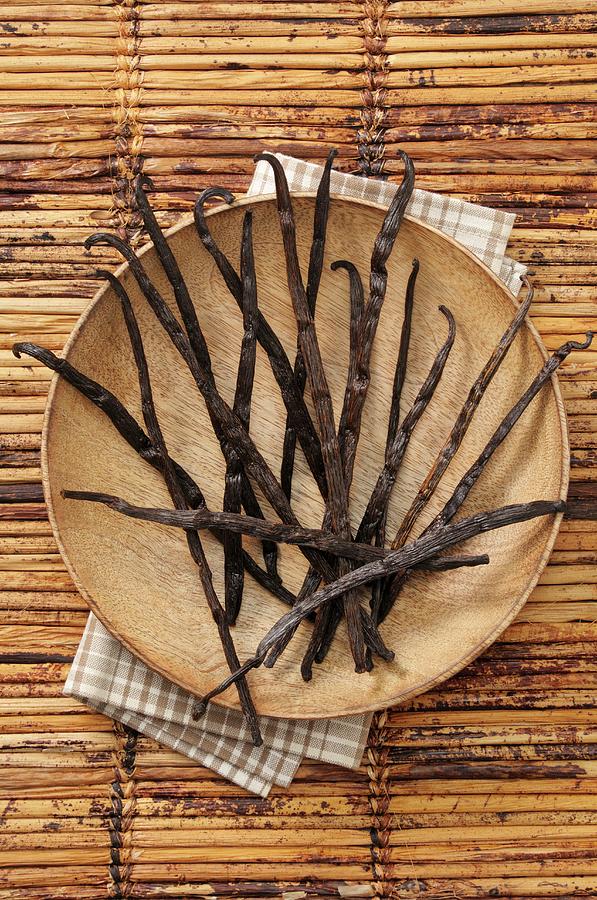Vanilla Pods On A Wooden Plate Photograph by Jean-christophe Riou