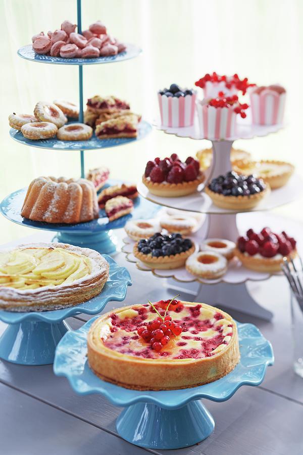 Various Cakes, Pastries And Biscuits On Cake Stands Photograph by Jalag / Olaf Szczepaniak