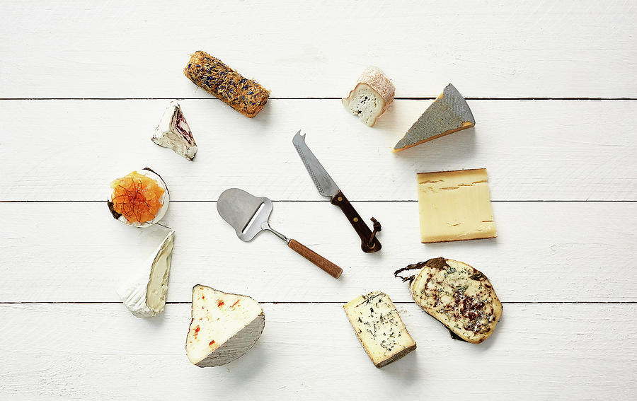 Various Cheeses With A Slicer And A Cheese Knife Photograph by Herbert Lehmann