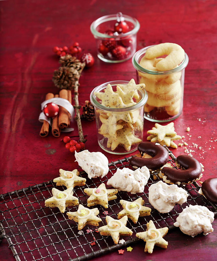 Various Christmas Biscuits On A Wire Rack And In Jars Photograph by Teubner Foodfoto