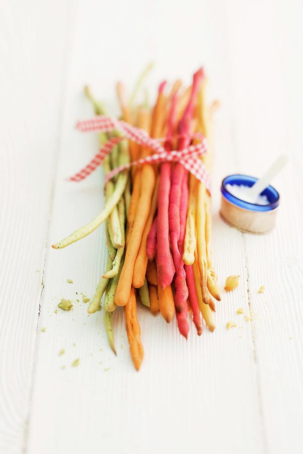 Various Coloured Breadsticks With Salt Photograph by Michael Wissing
