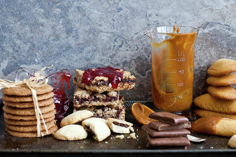 Various Cookies Stacked On An Antique Baking Sheet, With Jam And Caramel Sauce Photograph by Ryla Campbell