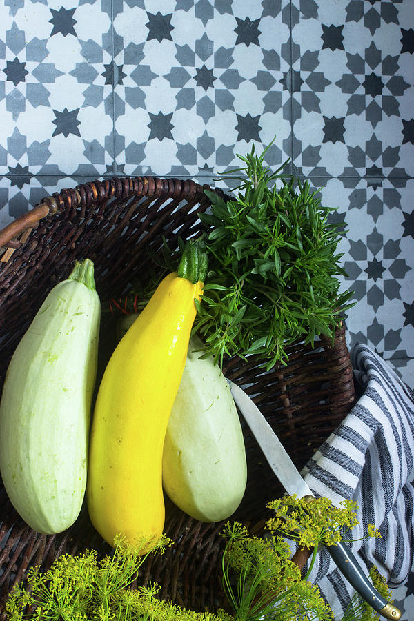 Various Courgettes In A Basket With Fresh Herbs Photograph by Charlotte Von Elm