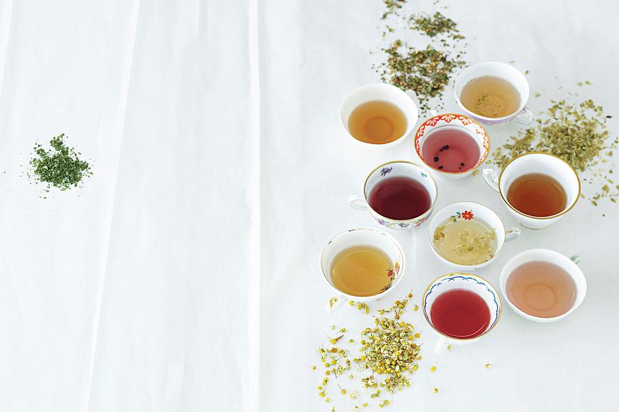Various Cups Of Tea Between Dried Herbs And Spices Photograph by Jalag / Janne Peters