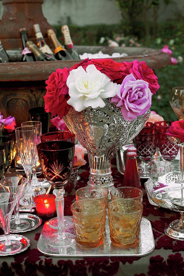 Various Cut Glasses And A Bunch Of Flowers On A Table At A Garden Party Photograph by Great Stock!