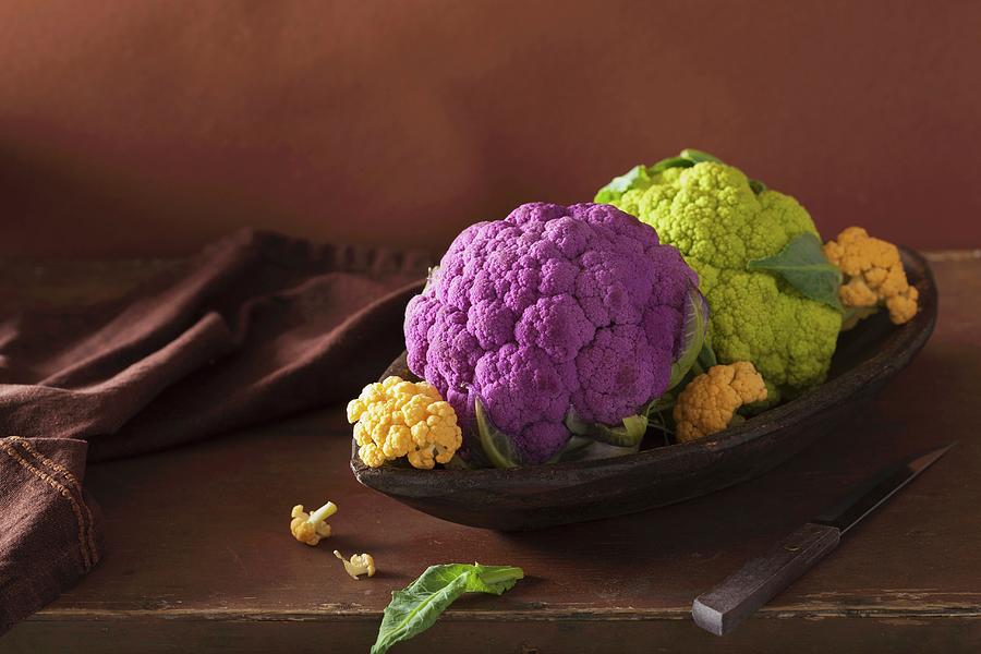 Various Different Coloured Cauliflower In A Wooden Dish Photograph by Olga Miltsova