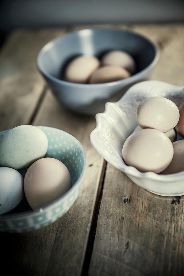 Various Eggs In Ceramic Bowls Photograph by Imagerie