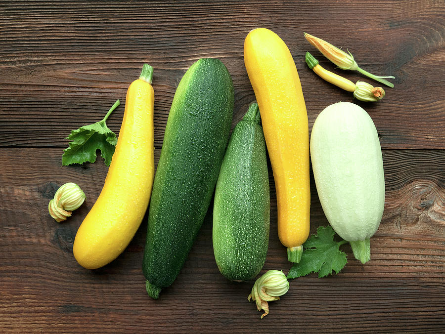 Various Fresh Yellow, Green And White Zucchini On A Wooden Background Photograph by Magdalena & Krzysztof Duklas
