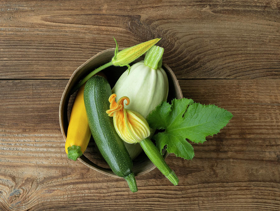Various Fresh Zucchini And Zucchini Flowers In A Bowl Photograph by Magdalena & Krzysztof Duklas