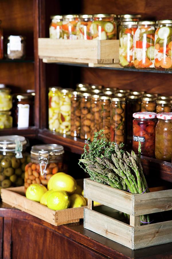 Various Jars Of Preserves, Fresh Lemons And Green Asparagus Photograph by Danny Lerner