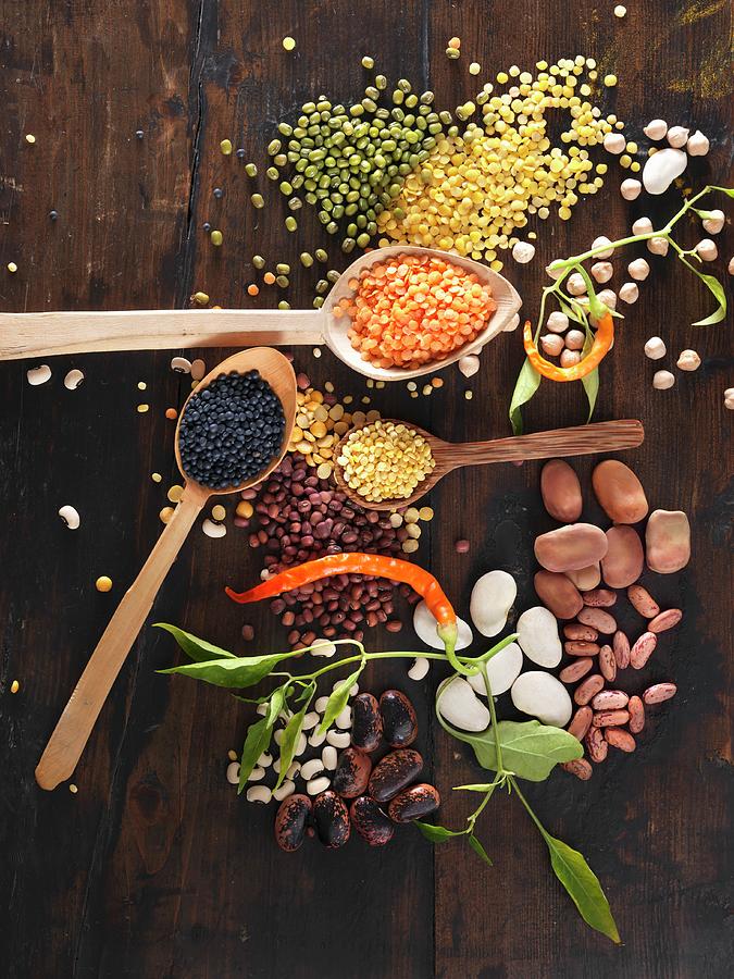Various Legumes On Wooden Spoons Photograph by Ulrike Koeb