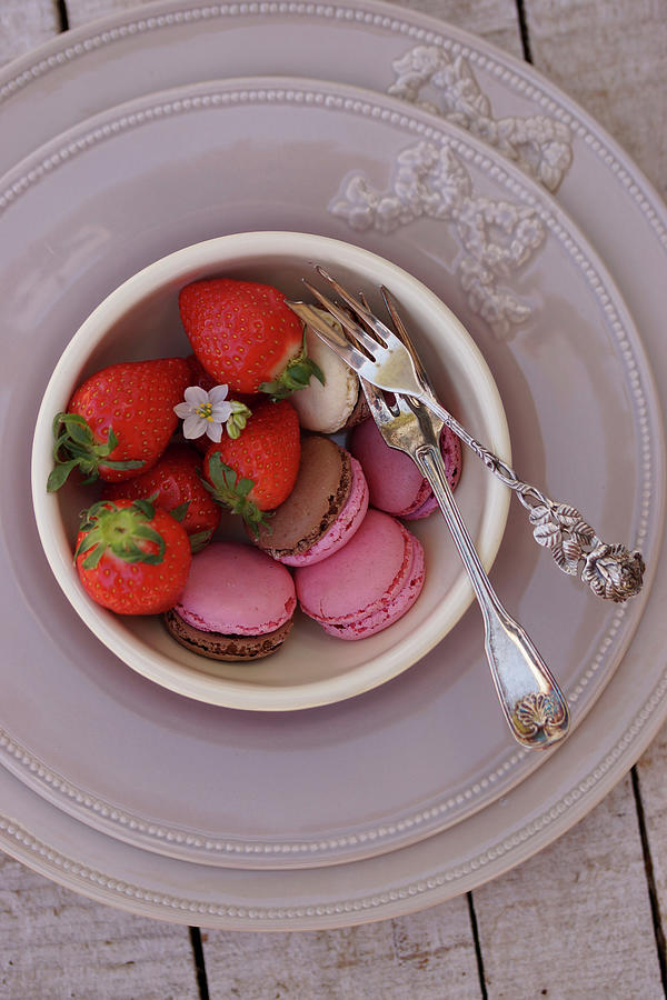 Various Macarons And Fresh Strawberries In Small Bowls On A Place Setting Photograph by Angelica Linnhoff