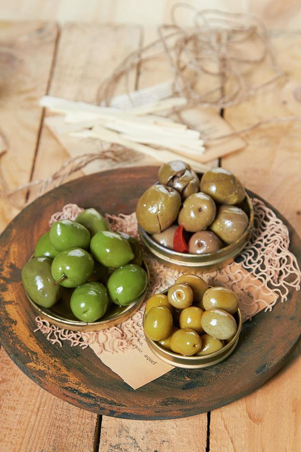 Various Marinated, Green Olives In Three Metal Lids Photograph by Miriam Rapado