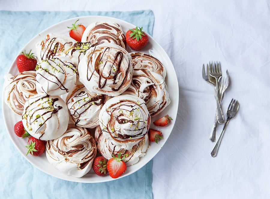 Various Meringues With Chocolate Sauce, Strawberries And Pistachio Nuts On A Plate seen From Above Photograph by Stacy Grant