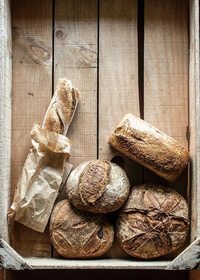 Various Pieces Of Bread On A Wooden Crate Photograph by Miriam Garcia