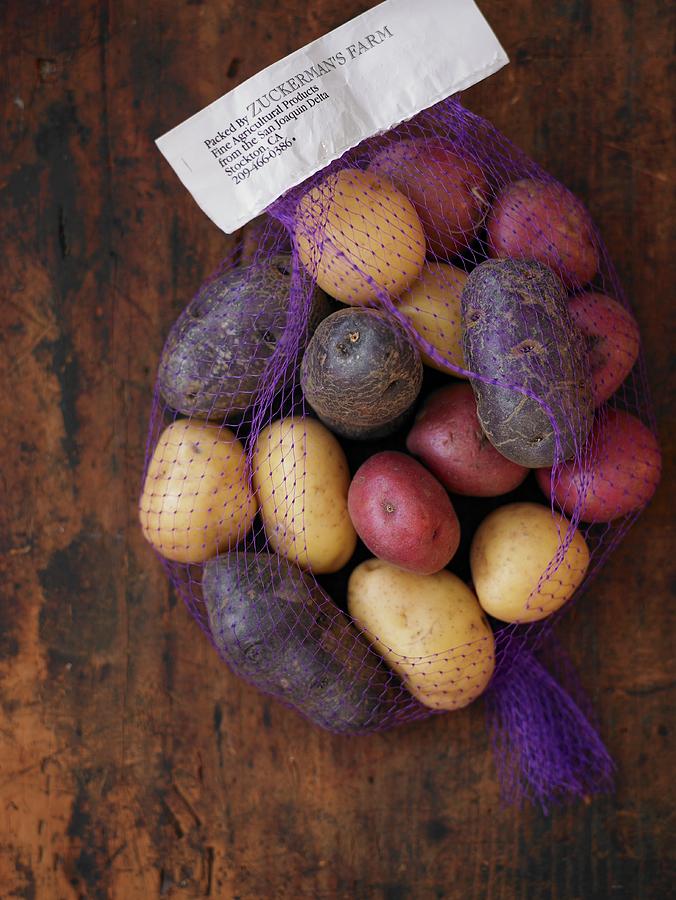 Various Potatoes In A Net Photograph by Leigh Beisch