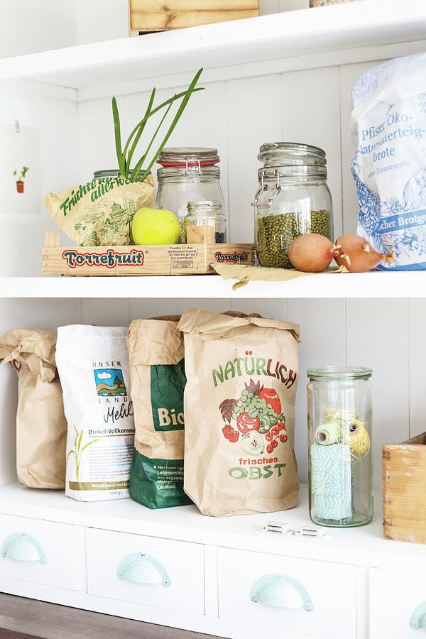 Various Recycled Paper Bags, Storage Jars And Fruit Crates On Kitchen Shelves Photograph by Syl Loves