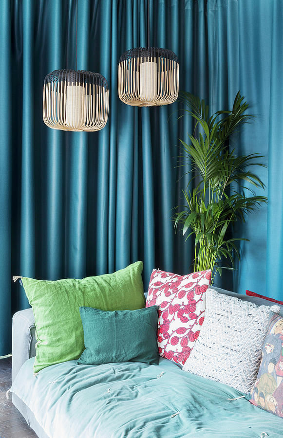 Various Scatter Cushions On Sofa In Front Of Petrol-blue Curtain Photograph by Anne-catherine Scoffoni