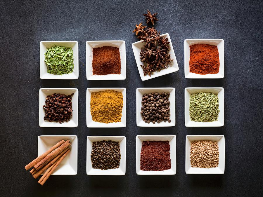 Various Spices In Square Dishes On A Chalkboard Surface Photograph by Don Crossland